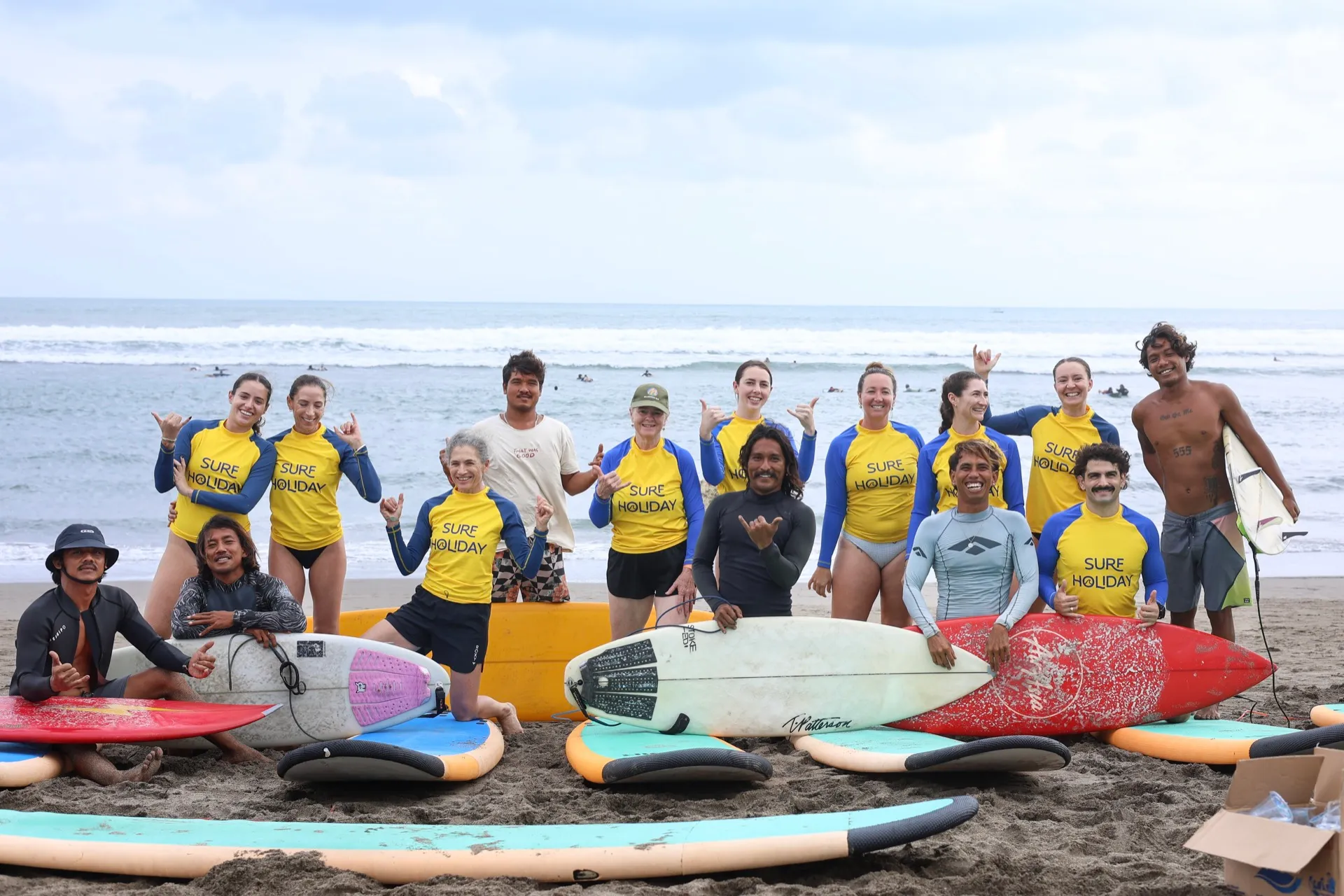 Surf Holiday Bali students and instructors with their boards on Batu Bolong beach, Canggu