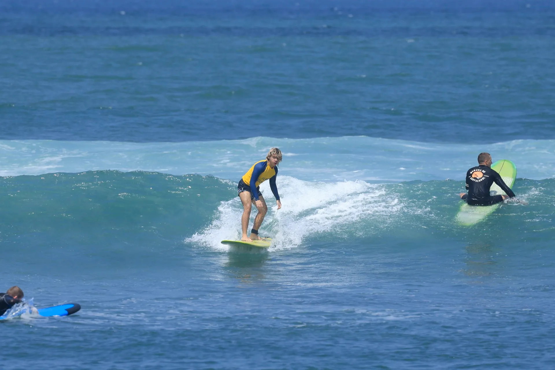 Coach guiding a student onto a wave during a Surf Holiday Bali lesson
